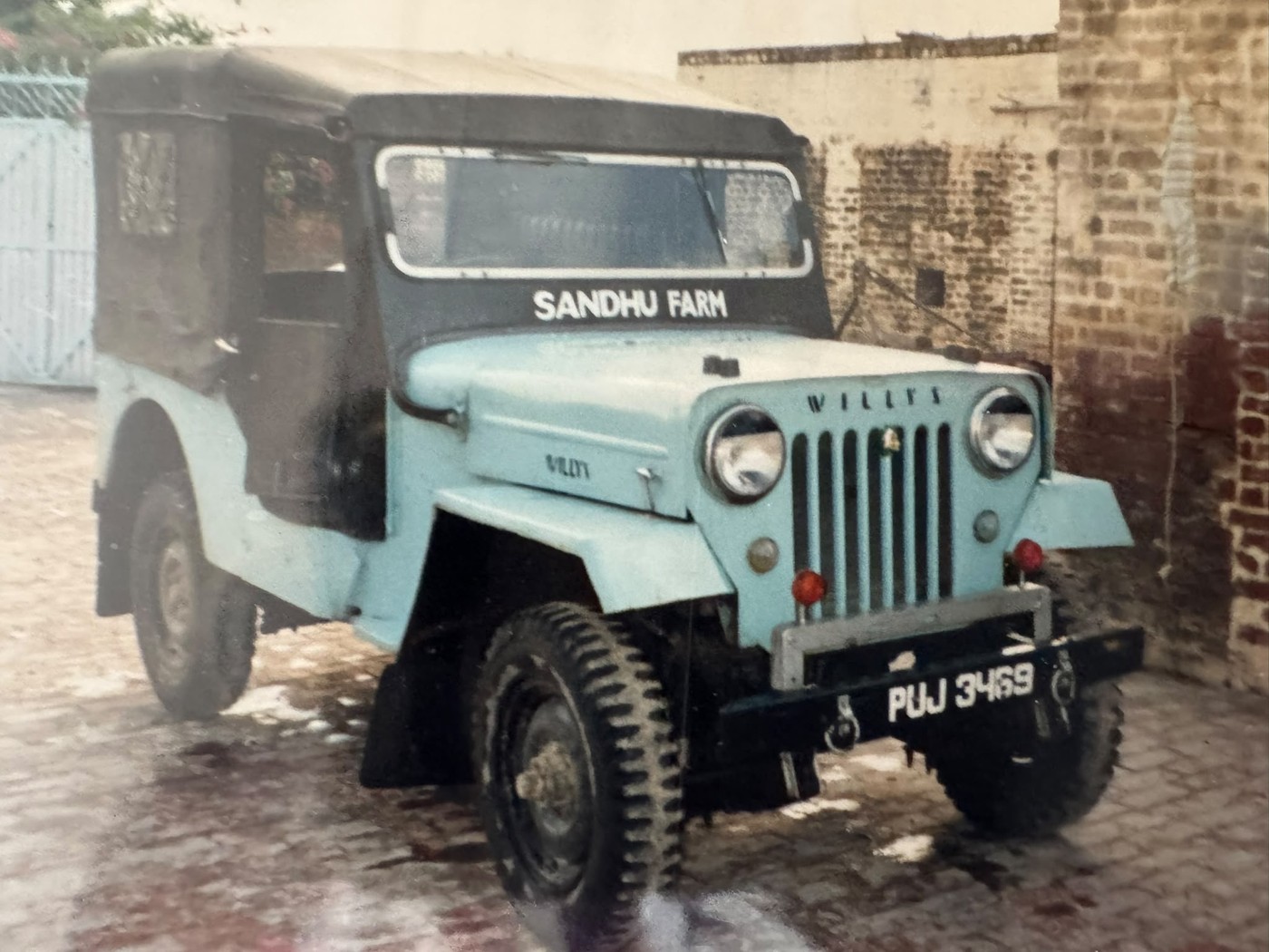 A Willys Jeep with 'Sandhu Farm' painted on it